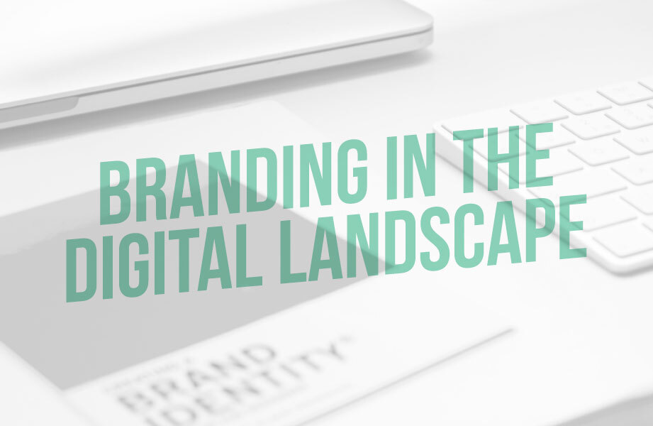 Text "Branding in the digital landscape" over a white workspace with a keyboard, laptop, and brand identity booklet.