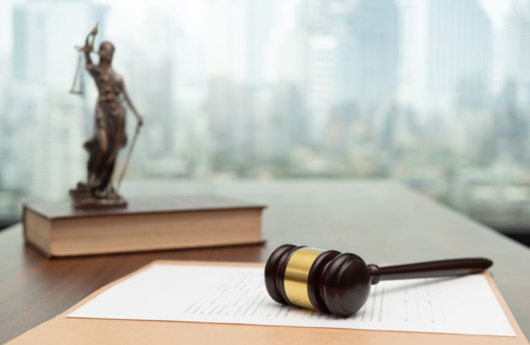 Gavel, Book and Blind Lady of Justice Statue on a Desk