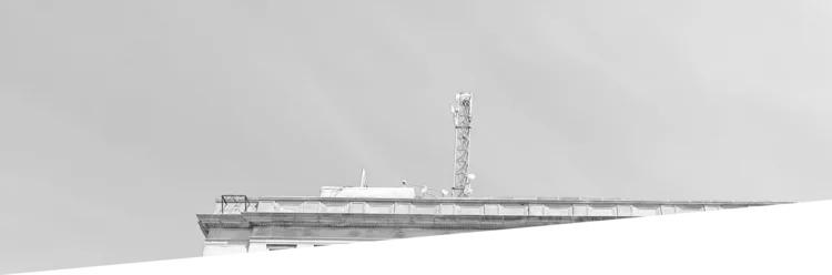 Black and white photo of a clock tower, showcasing its architectural details and timekeeping function