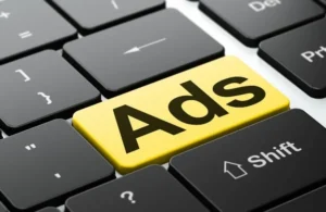 Close-up of a computer keyboard with a yellow key labeled "Ads" replacing the Enter key.